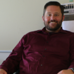 photo shows man at desk