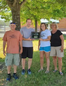 photo shows group of people holding award and smiling