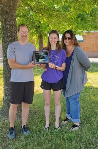 photo shows group of people holding award and smiling