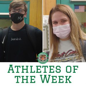 photo shows two students wearing masks and smiling