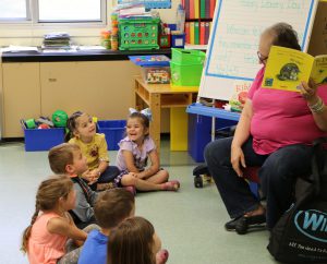 Pre-k students being read to.