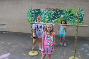 three second graders playing limbo