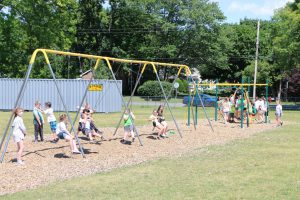 Intermediate School kids playing on the swingset