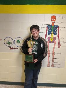 Louis McKinney posit with his trophy for winning Senior Sports award