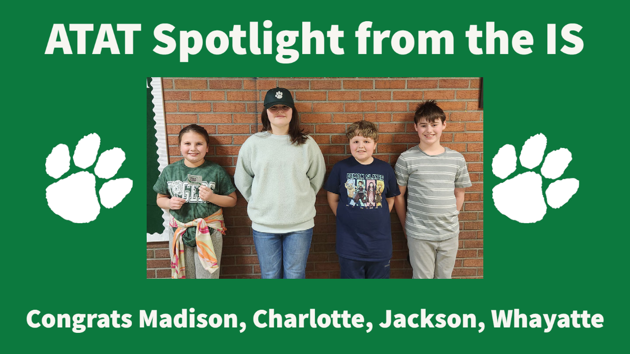 photo of 4 intermediate students in front of a brick wall