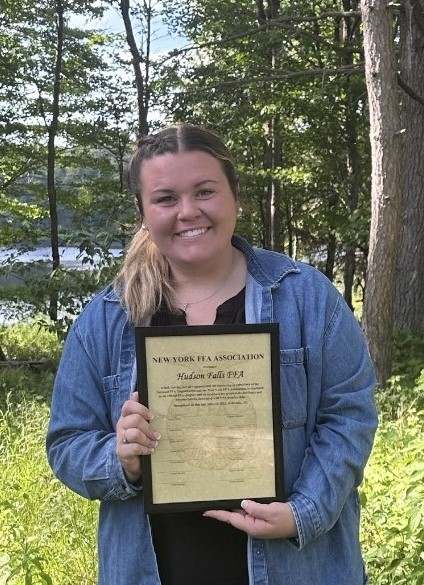Miss Hogan holding the plaque