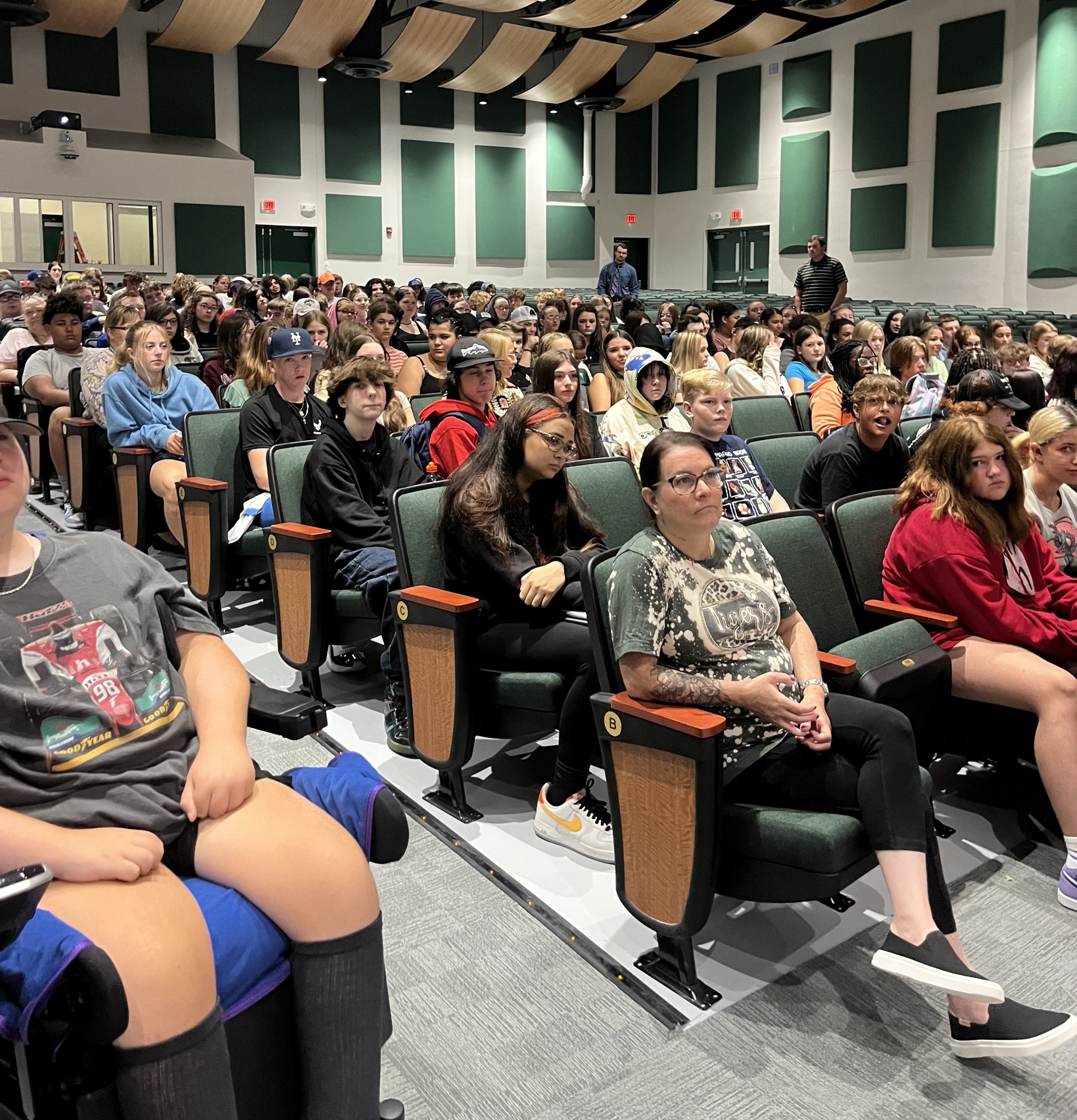 Photo of a group of students sitting in the auditorium for an assembly