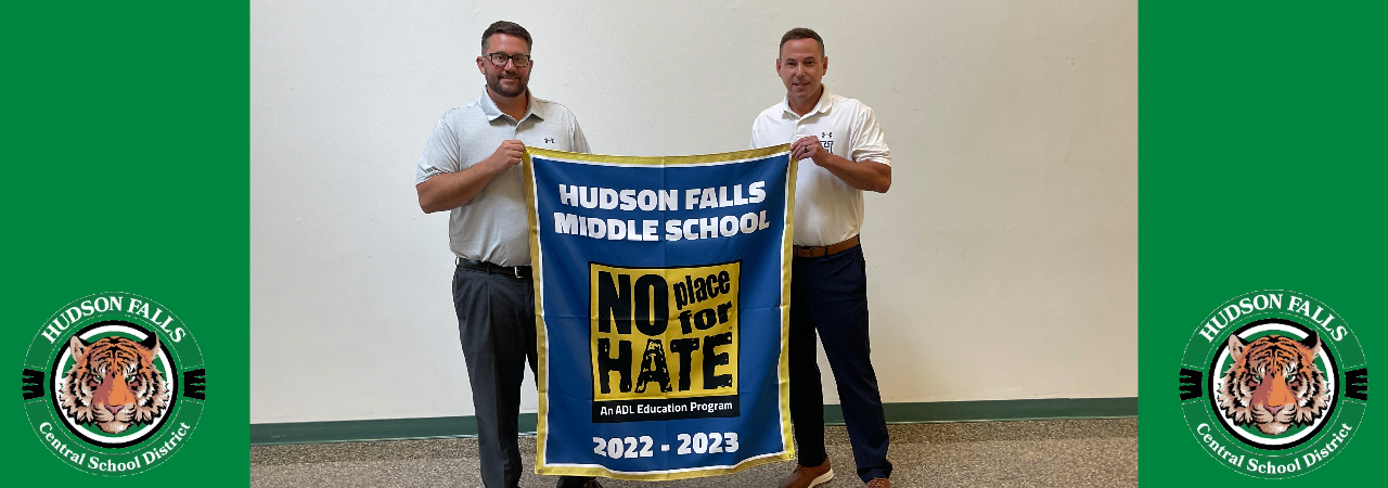 Middle school principals holding no place for hate banner