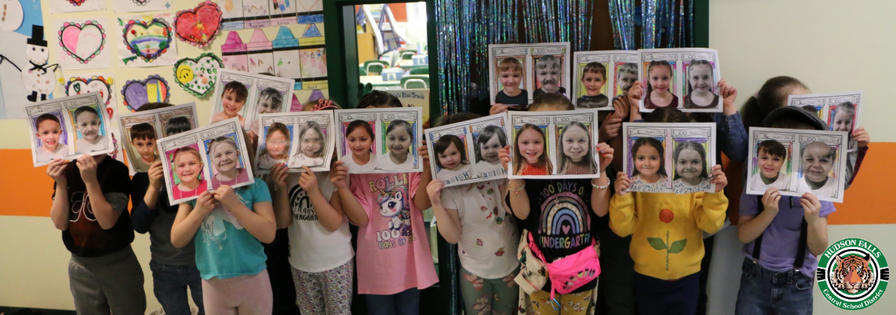 Photo of Kindergarteners holding a picture of themselves and a picture of what they would like like old for 100 days of school