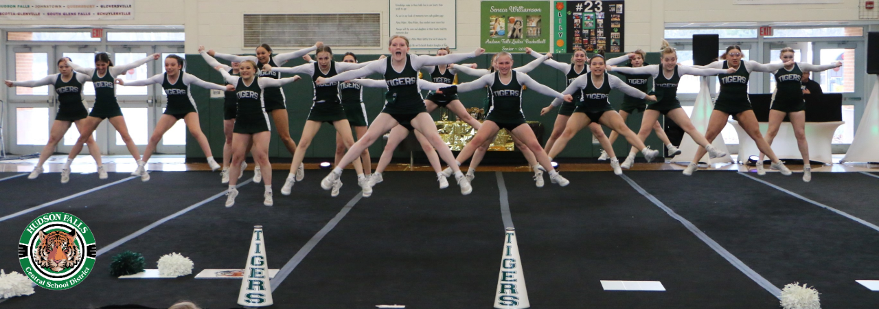 Photo of cheerleading squad performing a straddle jump