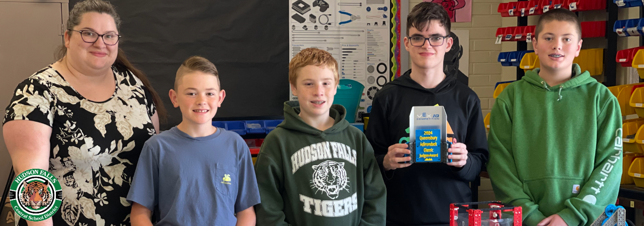 Photo of 4 students and their advisor displaying Vex Judges award