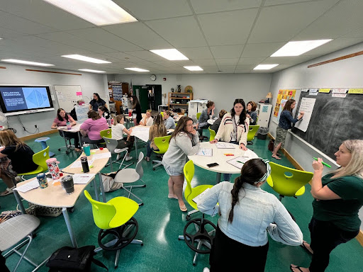 A room full of teachers receiving professional development in one of the newly furnished classrooms