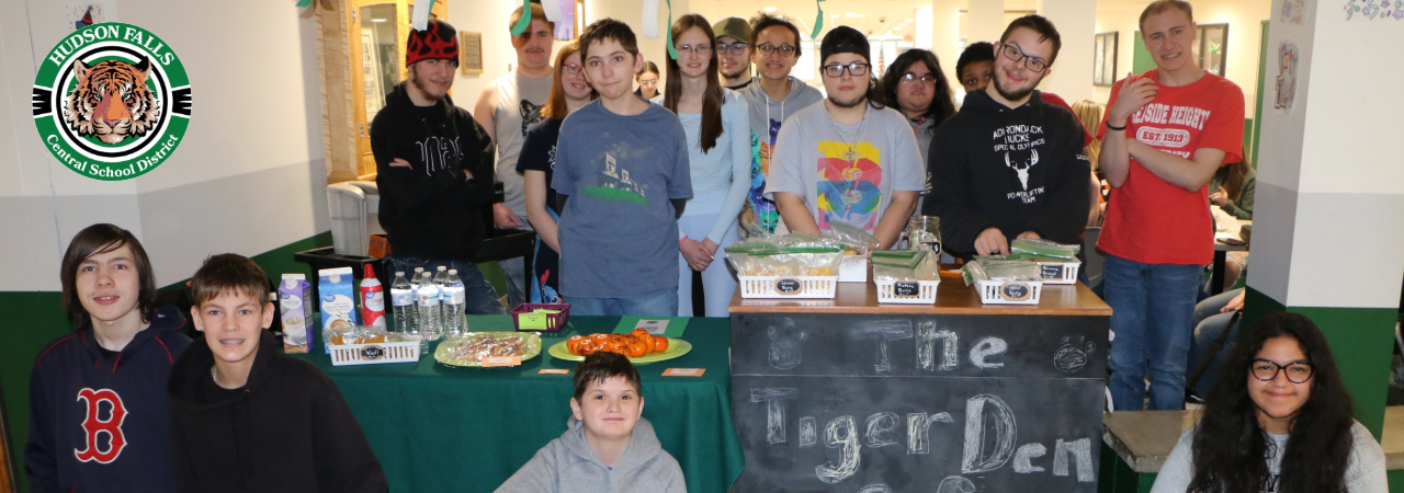 Photo of the members of the Tiger Den Cafe, in front of their coffee cart