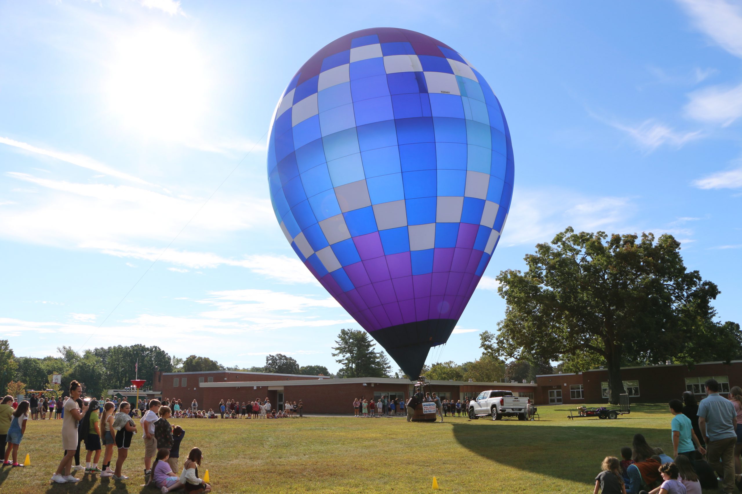 Photo of a blue, purple and white hot air balloon at the intermediate school 