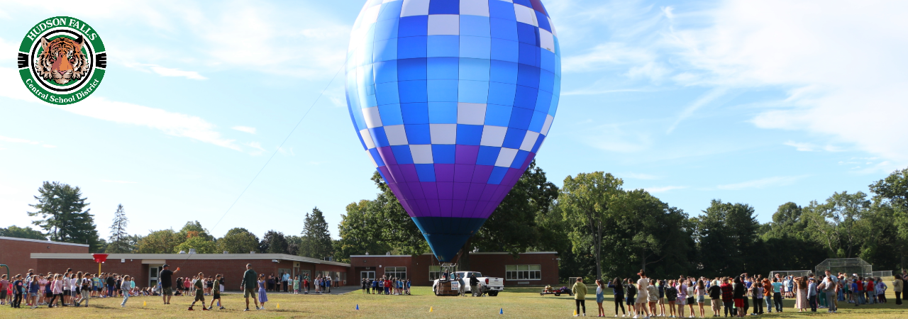 Photo of a blue, purple and white hot air balloon at the intermediate school