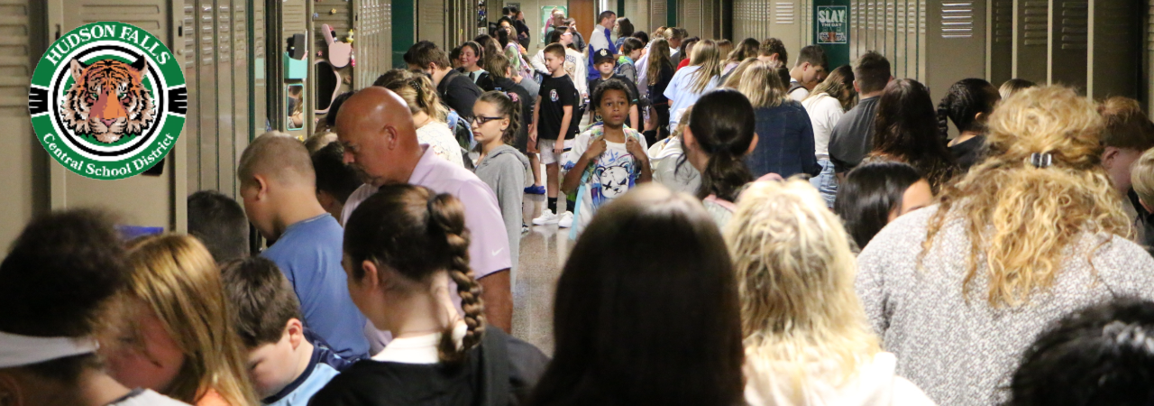 A hall full of MS students trying their lockers on the first day of school